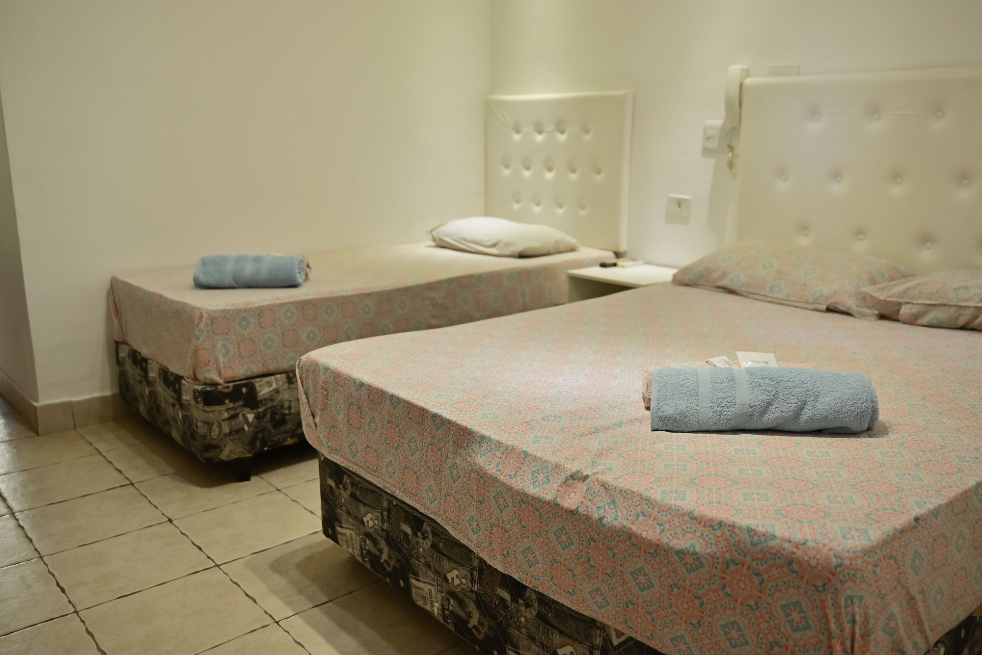 Quarto Duplo com cama de casal e cama de solteiro no Novo Hotel Pousada, em Interlagos